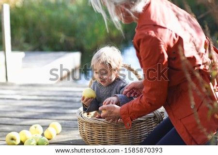 Similar – Image, Stock Photo Little girl woman carrying wicker basket with fresh organic apples