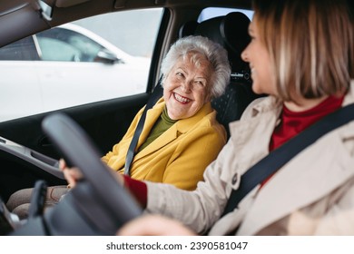 Granddaughter driving her elderly grandmother in the car, taking her to the doctor, shopping or to the bank. Caregiver driving elderly lady to the church, pharmacy. - Powered by Shutterstock