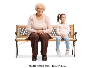 Granddaughter and grandmother sitting on a bench and smiling at the camera isolated on white background - Powered by Shutterstock