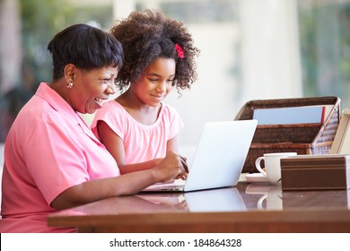 Granddaughter Helping Grandmother With Laptop - Powered by Shutterstock