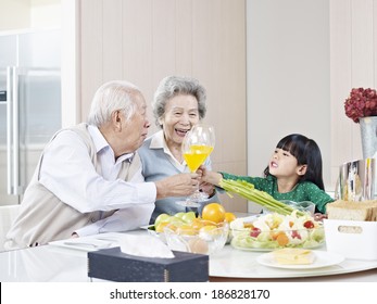 Granddaughter Toasting With Grandma And Grandpa