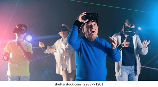 Grandfather amazed by playing VR games with family and taking his headset off. - Powered by Shutterstock