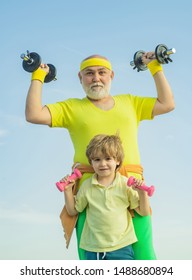 Grandfather And Child In Gym Working Out With Weights. I Love Sport. Body Care And Healthcare. Senior Man And Child In Family Health Club