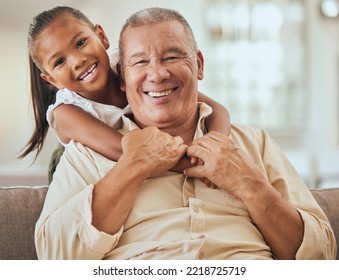 Grandfather, Child And Portrait With Hug In Home Lounge To Bond With Young And Cute Grandchild. Family, Elderly And Senior Grandpa In Indonesia Holding Kid With Happy Smile On Sofa In House.