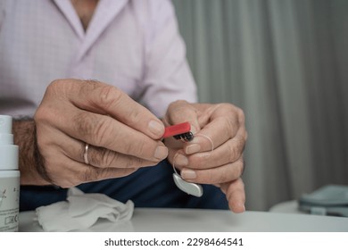 Grandfather cleaning his hearing aids so he can listen. - Powered by Shutterstock