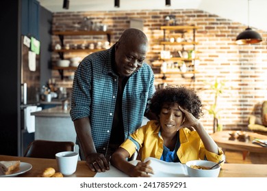 Grandfather doing homework with grandson at home - Powered by Shutterstock