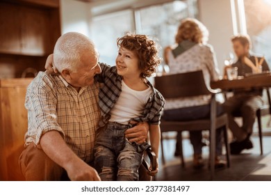 Grandfather embracing his grandson at home - Powered by Shutterstock