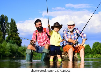 Grandfather, Father And Son Are Fly Fishing On River