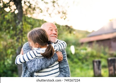 Grandfather giving his grandaughter a hug. - Powered by Shutterstock