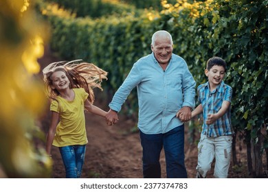 Grandfather giving a tour through the vineyard for his grandchildren - Powered by Shutterstock