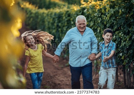 Grandfather giving a tour through the vineyard for his grandchildren