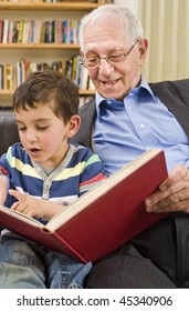 Grandfather And Grandchild Reading A Book