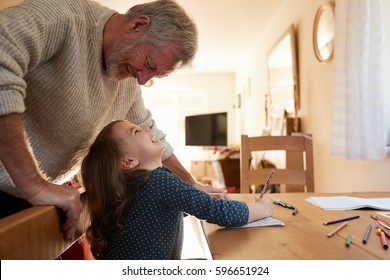 Grandfather And Granddaughter Colouring Picture Together - Powered by Shutterstock