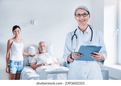 Grandfather, granddaughter and female asian doctor at hospital ward. Support and help of medical team. Respective and confident medical treatment concept - Powered by Shutterstock