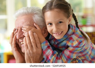 Grandfather and granddaughter having fun