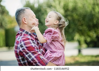 Grandfather With Granddaughter. Love You So Much My Grandpa. Grandpa Kissing Grandchild In Thr Park. Multi Generation Family Enjoying In The Park.