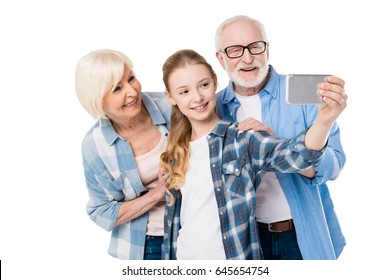 Grandfather, Grandmother And Granddaughter Taking Selfie Together Isolated On White