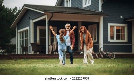Grandfather and Grandmother are Happy to Meet Their Granddaughter in Front of their Suburbs House. Grandparents Spending the Weekend with Kids, Enjoying Family Time with Grandchild.
