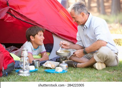 Grandfather And Grandson Cooking Breakfast On Camping Holiday - Powered by Shutterstock