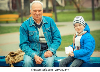 Grandfather And Grandson Eating Fries And Indulge