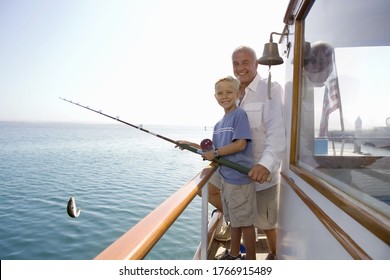 Grandfather And Grandson Fishing On Boat