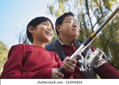 Grandfather And Grandson Fishing Portrait