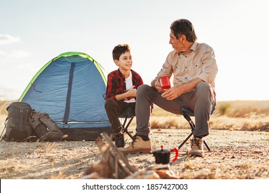 Grandfather and grandson having fun in camping. Concept of elderly people with active life. - Powered by Shutterstock