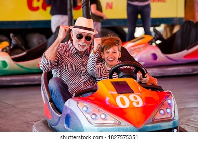 Grandfather And Grandson Hawe Fun In Bumper Car