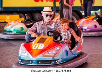 Grandfather And Grandson Hawe Fun In Bumper Car