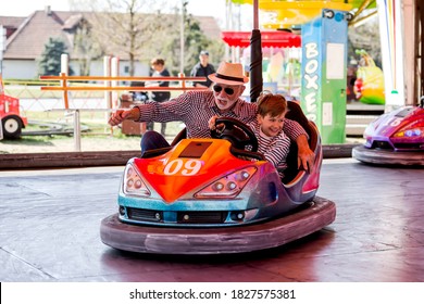 Grandfather and grandson hawe fun in bumper car