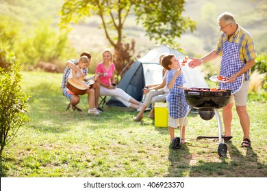 grandfather and grandson making barbecue for family
 - Powered by Shutterstock