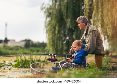 Grandfather With A  Grandson On Fishing.