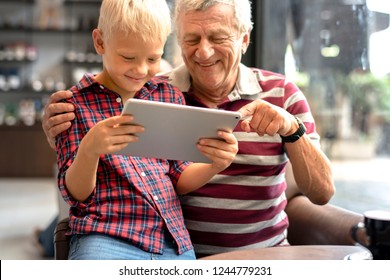 Grandfather And Grandson Playing A Video Game