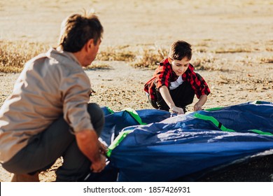 Grandfather and grandson setting up camping tent. Concept of elderly people with active life. - Powered by Shutterstock