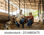 grandfather and grandson tend to a lamb in a barn while their dog sits nearby, enjoying time together on the farm.