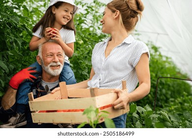 Grandfather growing organic vegetables with family at bio farm. People healthy food concept - Powered by Shutterstock