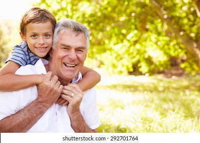 Grandfather Having Fun Outdoors With His Grandson, Portrait