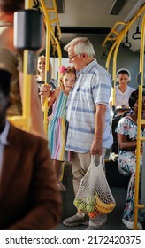 Grandfather And His Granddaughter Are In A Bus Going Home After Shopping For Groceries