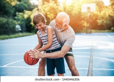 Grandfather And His Grandson Playing Basketball.