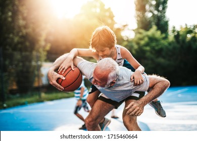 Grandfather And His Grandson Playing Basketball.