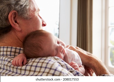 Grandfather Holding Sleeping Newborn Baby Granddaughter - Powered by Shutterstock