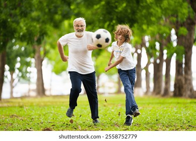 Grandfather and kids play football in sunny park. Happy family playing ball. Grandpa and children play soccer. Generation love. Active senior man with little boy. Grandchildren visit grandparents. - Powered by Shutterstock