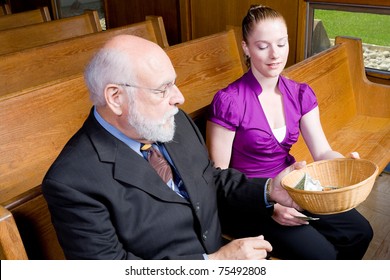 Grandfather Passing Offering Basket To Granddaughter In Church Pew.