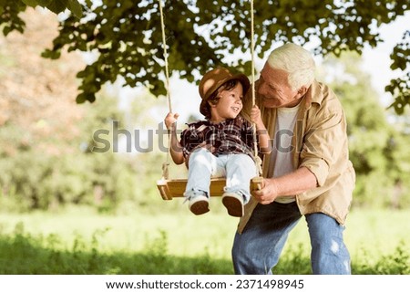 Similar – Image, Stock Photo Grandson on the swing (with a plaster on his knee)