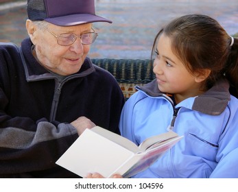 Grandfather reading a book - Powered by Shutterstock