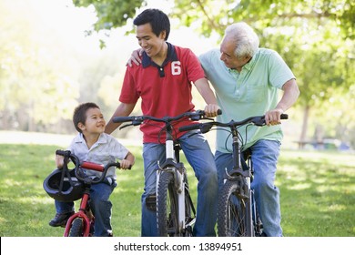 Grandfather Son And Grandson Bike Riding