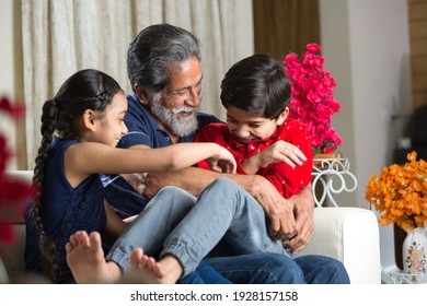 Grandfather Spending Leisure Time With Grandkids At Living Room