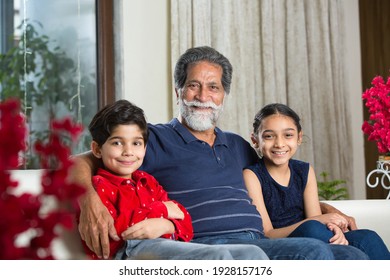 Grandfather Spending Leisure Time With Grandkids At Living Room