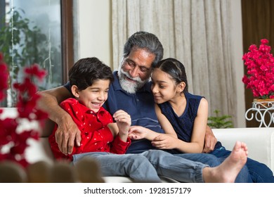 Grandfather Spending Leisure Time With Grandkids At Living Room