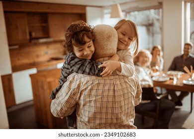 Grandfather spending time with his grandchildren at home - Powered by Shutterstock